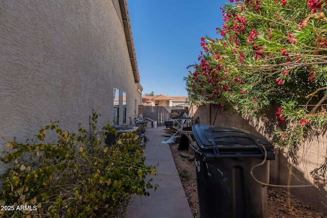 view of home's exterior featuring stucco siding and fence