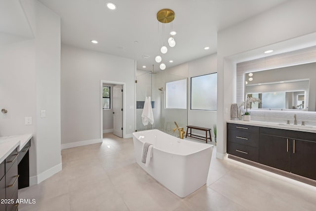 bathroom with vanity and shower with separate bathtub