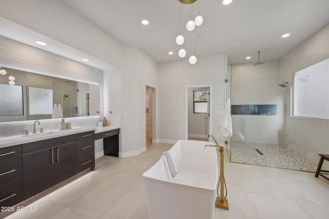 bathroom featuring a healthy amount of sunlight, plus walk in shower, and vanity