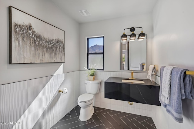 bathroom with tile patterned floors, vanity, and toilet