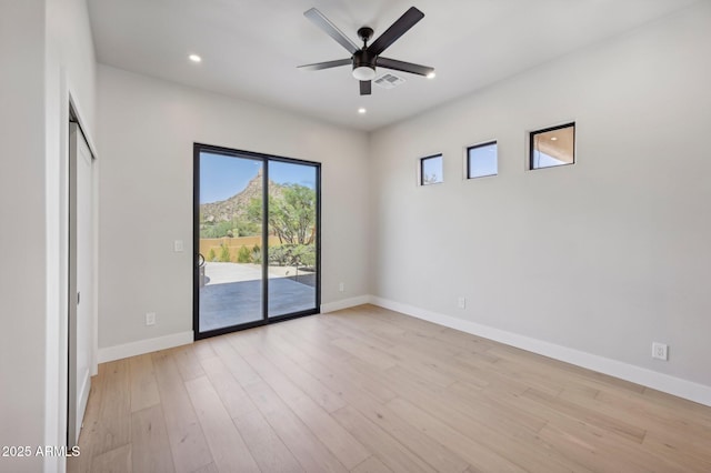 empty room featuring light wood-type flooring and ceiling fan