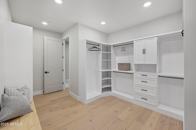 walk in closet with light wood-type flooring