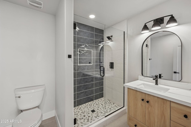 bathroom featuring a shower with door, tile patterned floors, vanity, and toilet