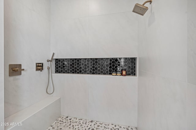 bathroom with a tile shower