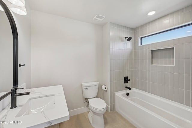 full bathroom with vanity, tiled shower / bath combo, and toilet