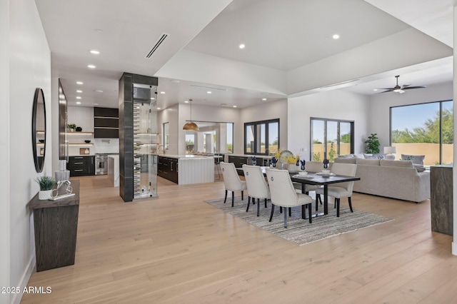 dining room featuring ceiling fan and light hardwood / wood-style flooring