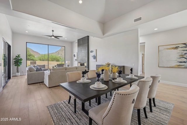 dining space featuring ceiling fan and light hardwood / wood-style flooring