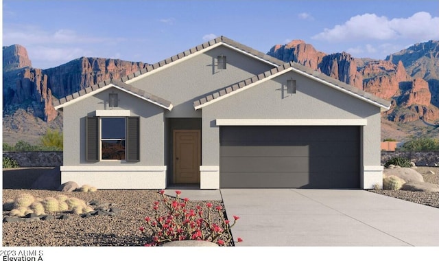 view of front of house with a garage and a mountain view