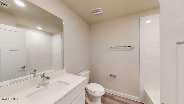 bathroom with vanity, hardwood / wood-style floors, and toilet