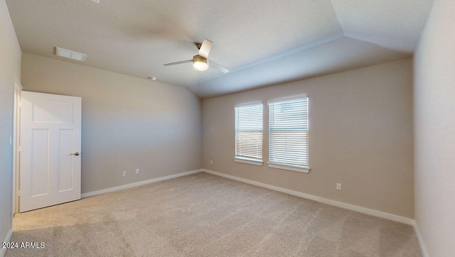 carpeted spare room with lofted ceiling and ceiling fan