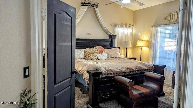 bedroom featuring ceiling fan and dark colored carpet