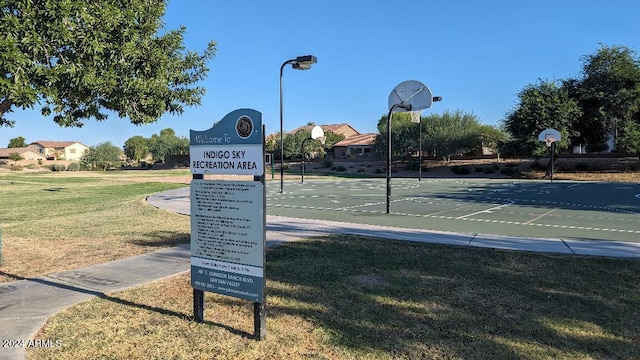 view of community with a yard and basketball court