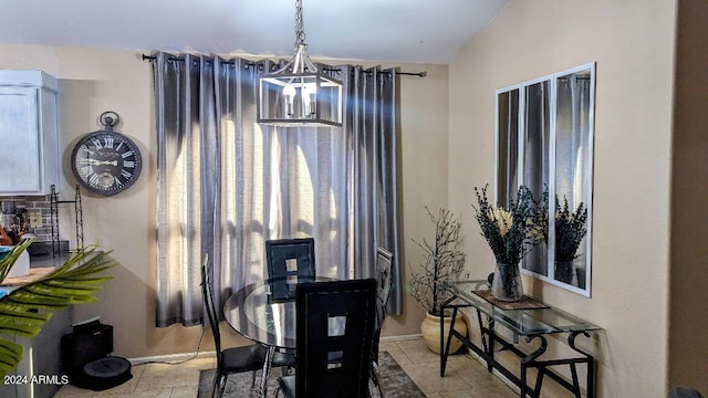 tiled dining area with a chandelier