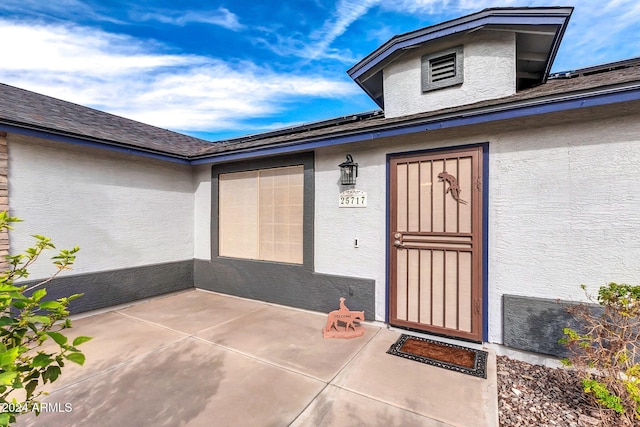 property entrance featuring a patio