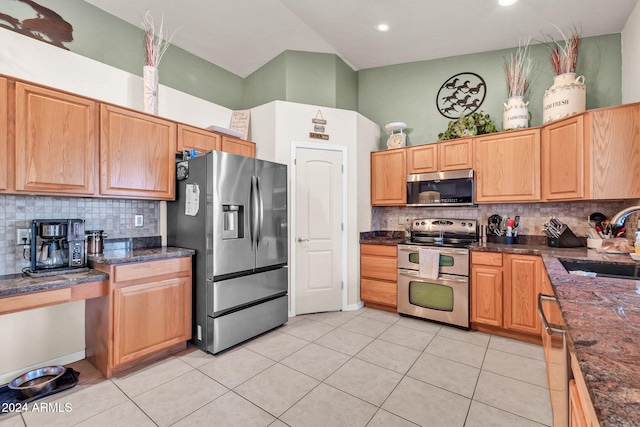 kitchen with light tile patterned floors, sink, decorative backsplash, and appliances with stainless steel finishes