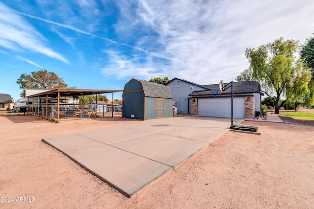 exterior space featuring a garage and a storage shed