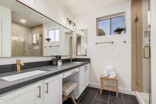 bathroom featuring tile patterned flooring, vanity, and walk in shower