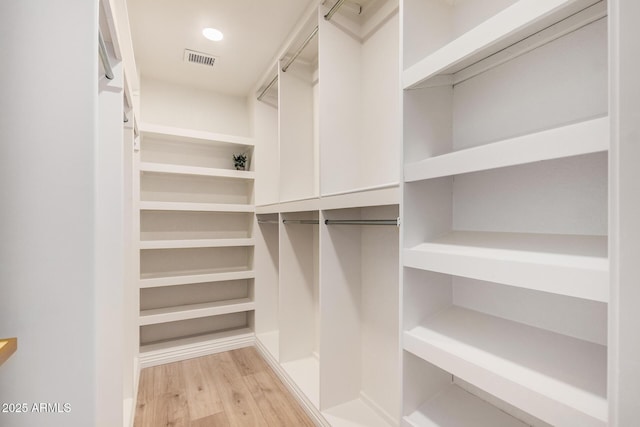 walk in closet featuring light hardwood / wood-style floors