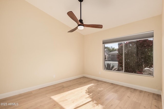 empty room with vaulted ceiling, ceiling fan, and light wood-type flooring