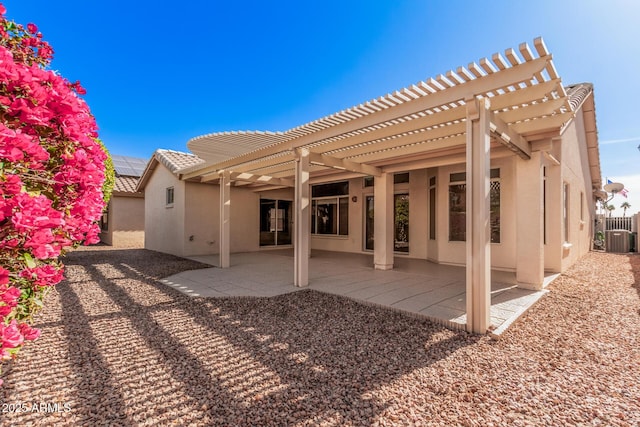 back of property featuring cooling unit, a pergola, and a patio area