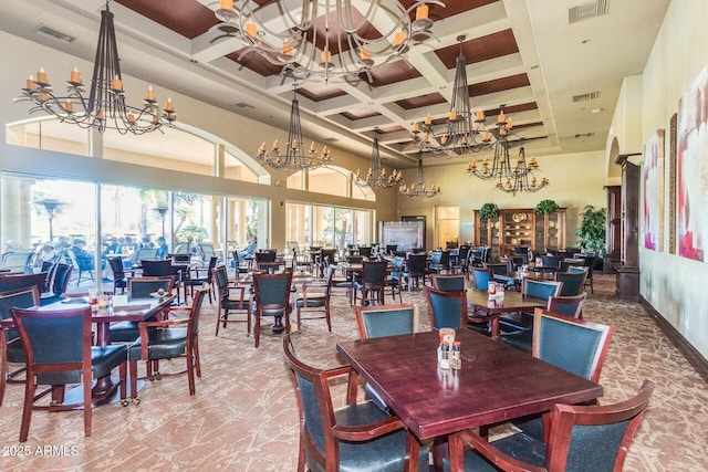 dining area featuring coffered ceiling, a notable chandelier, beam ceiling, and a high ceiling