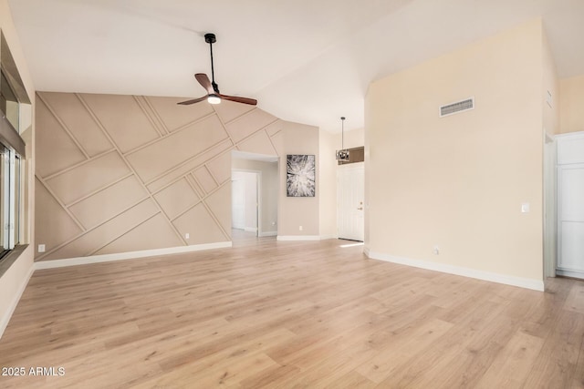 unfurnished living room with ceiling fan, lofted ceiling, and light wood-type flooring