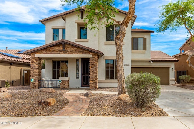 18171 W Marshall Ln, Surprise, AZ 85388 - view of front of house featuring a tile roof, stone siding, stucco siding, a porch, and driveway