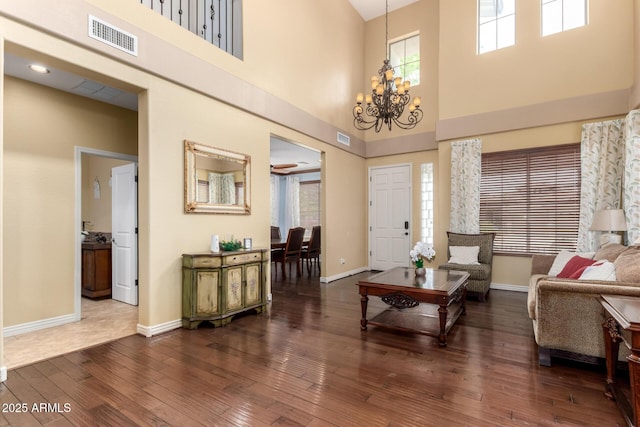 18171 W Marshall Ln, Surprise, AZ 85388 - living area featuring a high ceiling, a chandelier, baseboards, visible vents, and hardwood / wood-style flooring