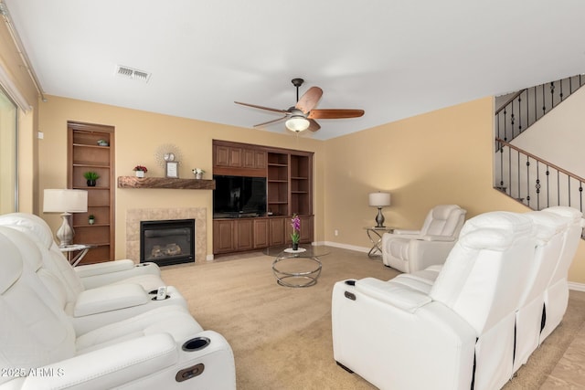 18171 W Marshall Ln, Surprise, AZ 85388 - living area with light carpet, a ceiling fan, baseboards, a tile fireplace, and visible vents