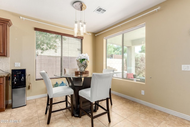 18171 W Marshall Ln, Surprise, AZ 85388 - dining room featuring visible vents, baseboards, light tile patterned floors, and a healthy amount of sunlight