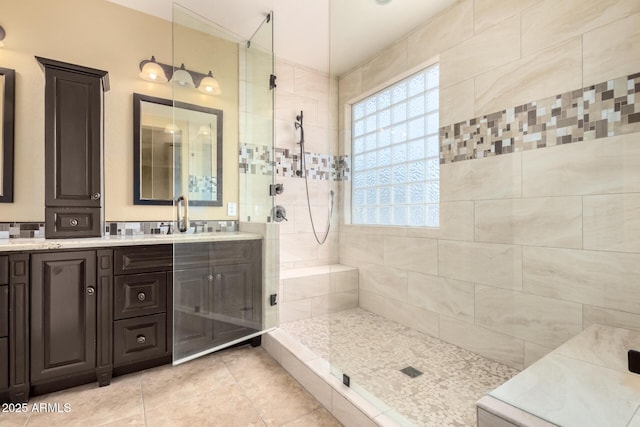 18171 W Marshall Ln, Surprise, AZ 85388 - full bathroom with a sink, tile patterned floors, double vanity, and tiled shower