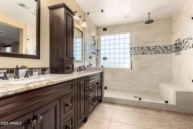 18171 W Marshall Ln, Surprise, AZ 85388 - bathroom with tile patterned flooring, double vanity, visible vents, a shower stall, and a sink