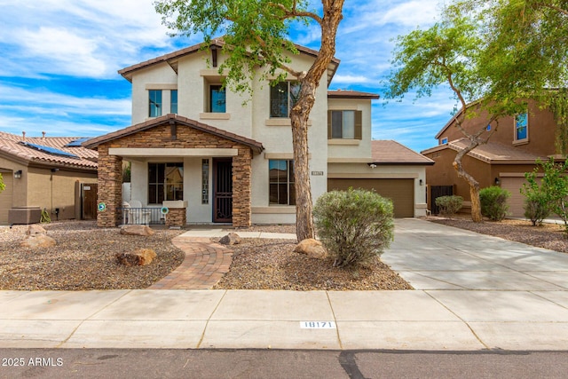 18171 W Marshall Ln, Surprise, AZ 85388 - view of front of home featuring concrete driveway, covered porch, stone siding, and stucco siding