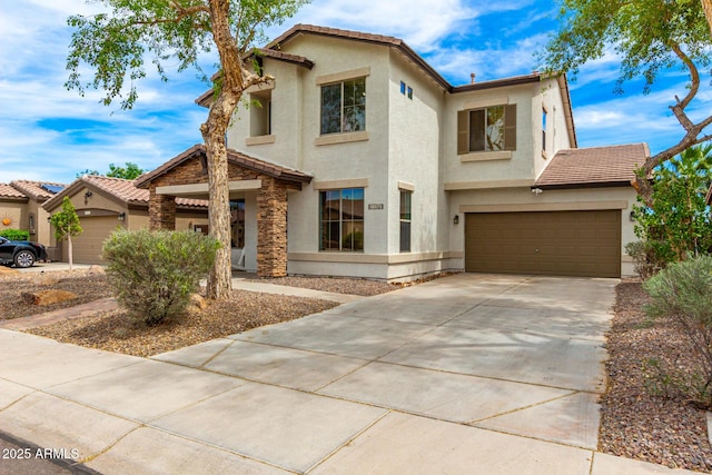 18171 W Marshall Ln, Surprise, AZ 85388 - mediterranean / spanish house featuring a garage, stucco siding, a tile roof, and concrete driveway