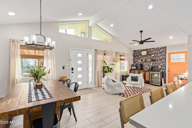 dining room featuring light wood-style floors, beamed ceiling, and a healthy amount of sunlight