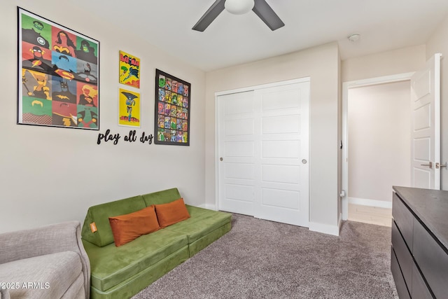 interior space with carpet floors, ceiling fan, and baseboards