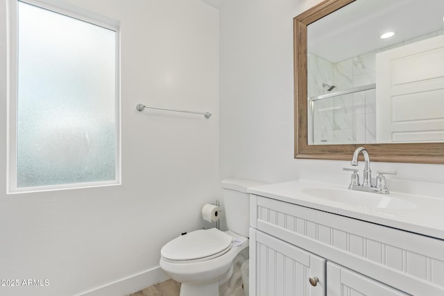 full bathroom with vanity, a marble finish shower, toilet, and baseboards