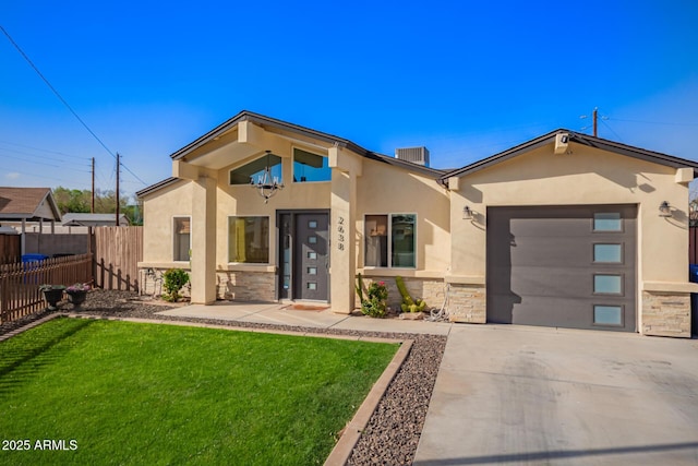 view of front facade featuring stucco siding, concrete driveway, fence, a garage, and stone siding