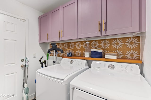 washroom with cabinet space and separate washer and dryer