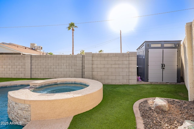 view of pool featuring a lawn, a fenced backyard, an in ground hot tub, a storage unit, and an outdoor structure