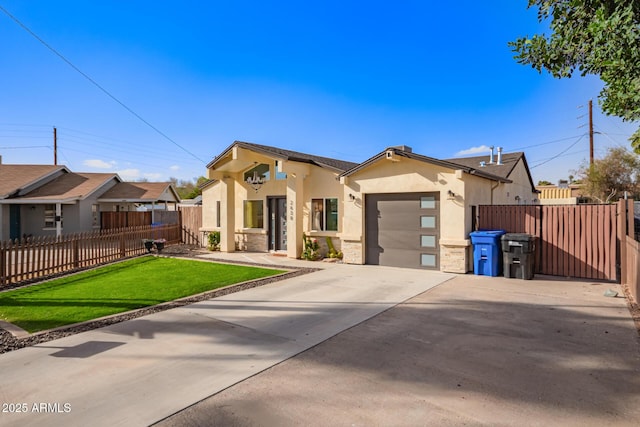 view of front facade with a garage, concrete driveway, fence, a front lawn, and stucco siding