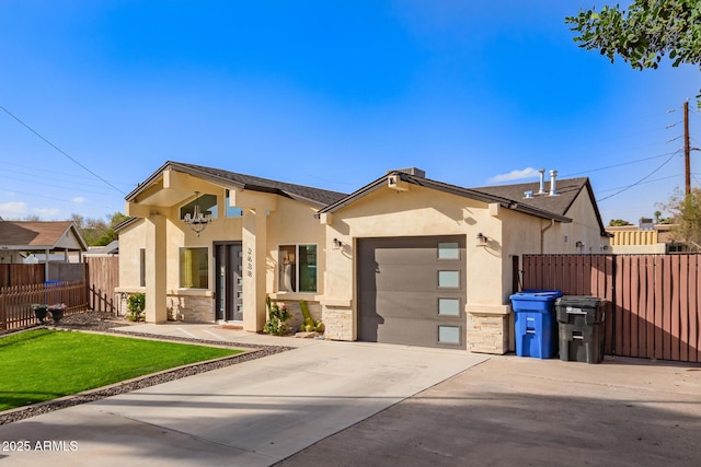 view of front facade featuring driveway, stone siding, an attached garage, fence, and stucco siding