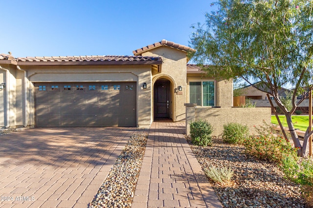 mediterranean / spanish house featuring a garage