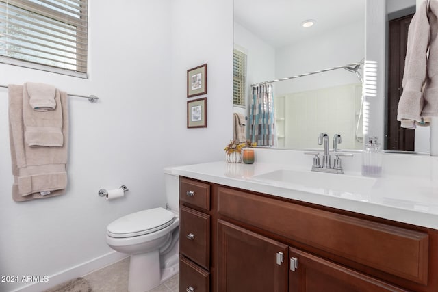 bathroom featuring walk in shower, vanity, tile patterned floors, and toilet