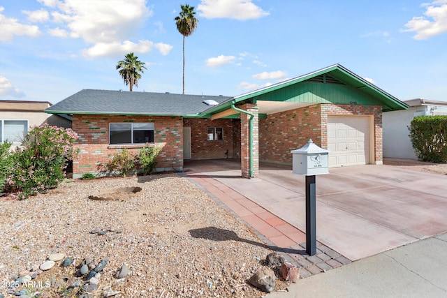 single story home featuring a garage, brick siding, roof with shingles, and concrete driveway