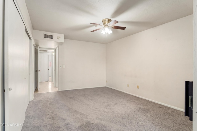 unfurnished room featuring visible vents, baseboards, carpet, and a ceiling fan