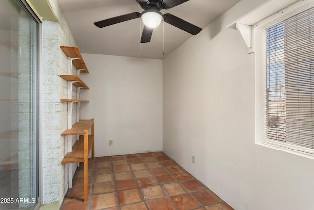 unfurnished room with a wealth of natural light and a ceiling fan