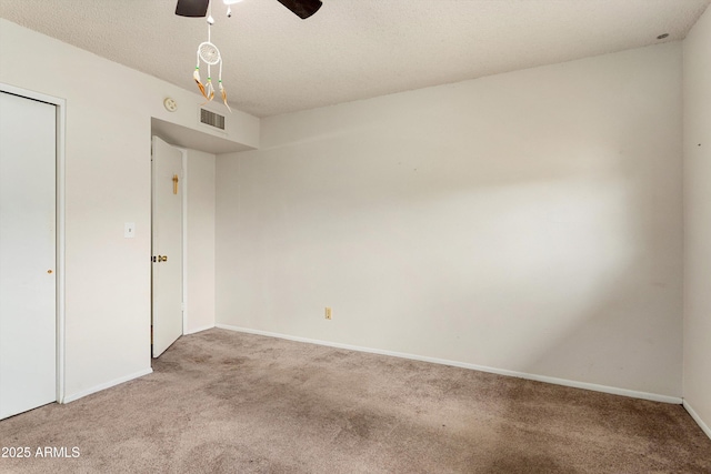 unfurnished room with visible vents, light carpet, a ceiling fan, a textured ceiling, and baseboards