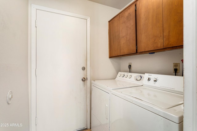 washroom featuring cabinet space and independent washer and dryer