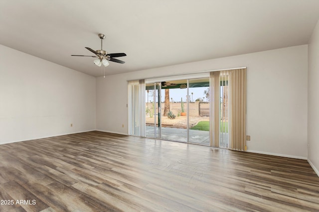 empty room with baseboards, a ceiling fan, and wood finished floors